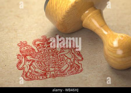 United Kingdom coat of arms stamp with rubber stamp on craft paper. 3d illustration Stock Photo