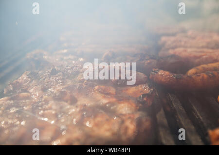 Preparing grilled mixed meat on barbecue grill over charcoal . Stock Photo
