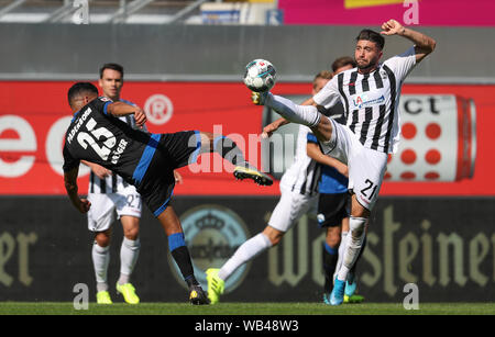 Paderborn, Germany. 24th Aug, 2019. Soccer: Bundesliga, SC Paderborn 07 - SC Freiburg, 2nd matchday in the Benteler Arena. Paderborn's Mohamed Dräger (l) in the fight for the ball with Brandon Borrello (r) from Freiburg. Credit: Friso Gentsch/dpa - IMPORTANT NOTE: In accordance with the requirements of the DFL Deutsche Fußball Liga or the DFB Deutscher Fußball-Bund, it is prohibited to use or have used photographs taken in the stadium and/or the match in the form of sequence images and/or video-like photo sequences./dpa/Alamy Live News Stock Photo