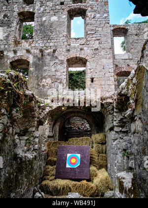 a view of an old ruins of a castle or fortress with a bow target Stock Photo