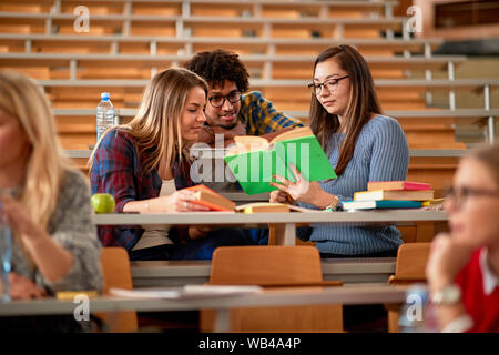 young student’s discussion and writing together at college Stock Photo