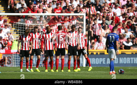 Leicester City's James Maddison (right) takes a free kick during the Premier League match at Bramall Lane, Sheffield. Stock Photo