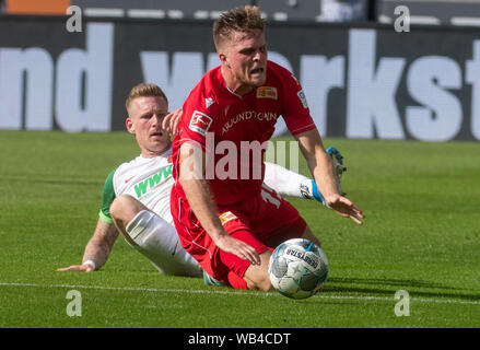 Augsburg, Germany. 24th Aug, 2019. Soccer: Bundesliga, FC Augsburg - 1st FC Union Berlin, 2nd matchday in the WWK-Arena. Andre Hahn from Augsburg (l) and Berlin's Marius Bülter fight a duel. Credit: Stefan Puchner/dpa - IMPORTANT NOTE: In accordance with the requirements of the DFL Deutsche Fußball Liga or the DFB Deutscher Fußball-Bund, it is prohibited to use or have used photographs taken in the stadium and/or the match in the form of sequence images and/or video-like photo sequences./dpa/Alamy Live News Stock Photo