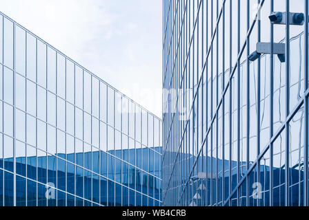 deserted high-tech style cityscape, fragment of glass and metal building facades with surveillance cameras Stock Photo
