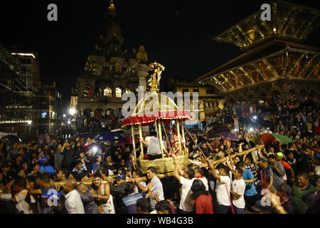 Lalitpur, Nepal. 24th Aug, 2019. Nepalese devotees carry a chariot of Deity Bhimsen on a procession along the ancient city of Patan during Bhimsen festival in Lalitpur, Nepal on Saturday, August 24, 2019. Deity Bhimsen is worshipped in belief of prosperity to ones business. Credit: Skanda Gautam/ZUMA Wire/Alamy Live News Stock Photo