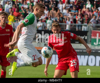 Augsburg, Germany. 24th Aug, 2019. Soccer: Bundesliga, FC Augsburg - 1st FC Union Berlin, 2nd matchday in the WWK-Arena. Alfred Finnbogason of Augsburg (l) and Berlin's Christopher Lenz fight a duel. Credit: Stefan Puchner/dpa - IMPORTANT NOTE: In accordance with the requirements of the DFL Deutsche Fußball Liga or the DFB Deutscher Fußball-Bund, it is prohibited to use or have used photographs taken in the stadium and/or the match in the form of sequence images and/or video-like photo sequences./dpa/Alamy Live News Stock Photo