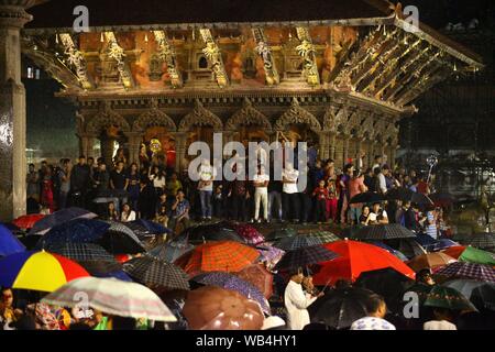 Lalitpur, Nepal. 24th Aug, 2019. People gather to offer prayers during Bhimsen Festival at Patan Durbar Square in Lalitpur, Nepal, Aug. 24, 2019. People from Newar community celebrated the Bhimsen Festival carrying the palanquin along with the idol of God Bhimsen as a part of the religious procession as they travel around the city. Nepalese people worship God Bhimsen as the 'God of Commerce, Industry & Fortunes'. Credit: Sunil Sharma/Xinhua Stock Photo
