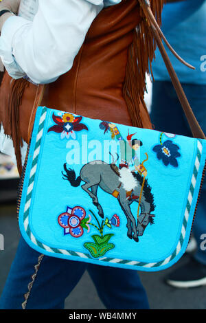 a young woman with a beaded native american purse visits the santa fe indian market in new mexico usa wb4mmy
