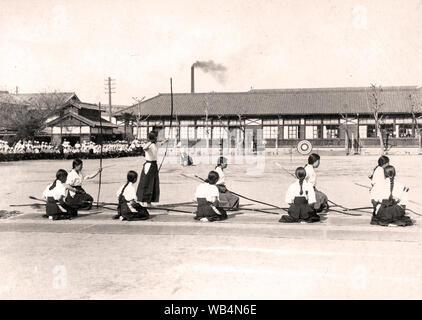 [ 1930s Japan - Japanese Female Students Practicing Kyudo ] —   A group of female high school students practicing Kyudo (Japanese archery).  This photo comes from a year album for 1935 (Showa 10) of a girls’ school in Okayama City, Okayama Prefecture.  20th century vintage gelatin silver print. Stock Photo