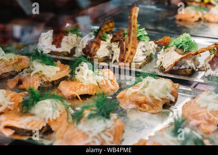 Selection of traditional open-faced Danish sandwiches,  smorrebrod, inside display case at a food market in Copenhagen, Denmark. Stock Photo