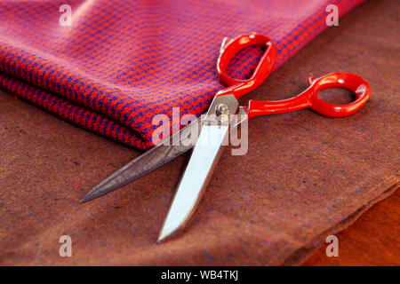 Sewing equipment composition on the table: scissors, fabric. Fashion designers studio Stock Photo