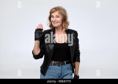 Elderly caucasian woman in black leather jacket. Studio shot Stock Photo