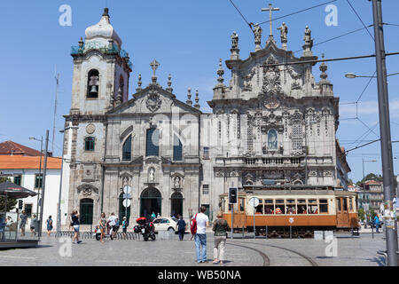 A tramway stopping in front of the Carmo Church and the Carmelite Church in Porto, Portugal. Stock Photo