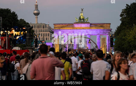 Berlin, Germany. 24th Aug, 2019. On the Straße des 17. Juni people follow the open-air concert of the Berliner Philharmoniker under the direction of the new chief conductor Petrenko. Credit: Paul Zinken/dpa/Alamy Live News Stock Photo