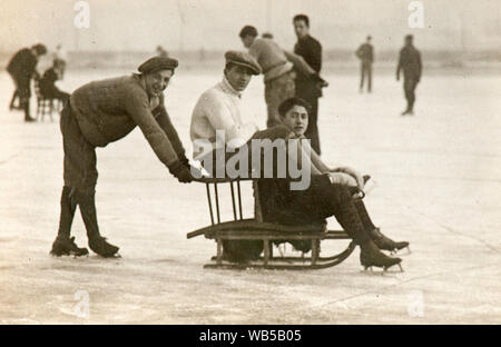 Group of friends having fun together skating on ice (Turin, Italy). The picture was probably taken in 1920 Stock Photo