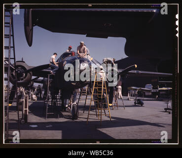 Employees on the Sunshine assembly line at North American's plant put the finishing touches on another B-25 bomber, Inglewood, Calif. In addition to the battle-tested B-25 (Billy Mitchell) bomber, used in General Doolittle's raid on Tokyo, this plant produces the P-51 (Mustang) fighter plane which was first brought into prominence by the British raid on Dieppe Abstract/medium: 1 transparency : color. Stock Photo