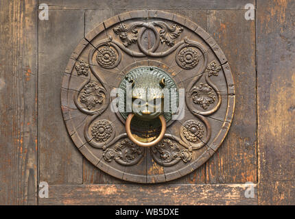 July 01 2019 the sun shines on the lion's head of a door knocker at the cathedral in Augsburg / Germany Stock Photo