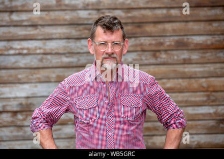 portrait of handsome bearded man in his 50s standing outside Stock Photo