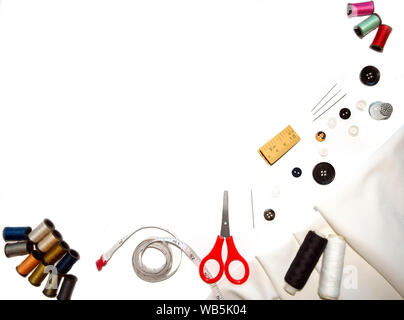 Copy-space frame with sewing tools and  fabric on white background Stock Photo