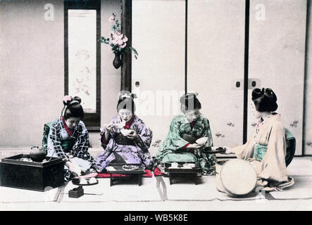 [ 1890s Japan - Japanese Women Having a Meal ] —   Having a meal. Four young women in kimono are seated on the floor. One woman is holding out a tray for the woman handing her a bowl. Another one is eating with chopsticks, while the one on the left is pouring tea.  Albumen photograph sourced by Kozaburo Tamamura (1856-1923?), 1890s, for 'Japan, Described and Illustrated by the Japanese', Shogun Edition edited by Captain F Brinkley. Published in 1897 by J B Millet Company, Boston Massachusetts, USA.  19th century vintage albumen photograph. Stock Photo