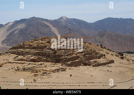 View of a pyramid  of the ancient sacred citadel of Caral. The sacred city of Caral is considered as the oldest civilization in America, its remains date from 3,500 BC. Stock Photo