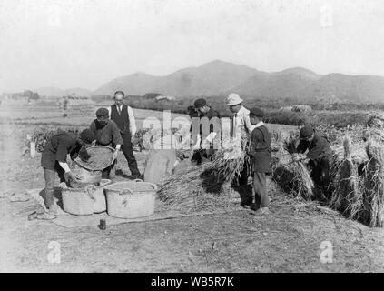[ 1930s Japan - Japanese Elementary School Students ] —   Japanese male elementary school children in school uniform are working on the land as two adults watch. c1920s or 1930s.  20th century vintage gelatin silver print. Stock Photo