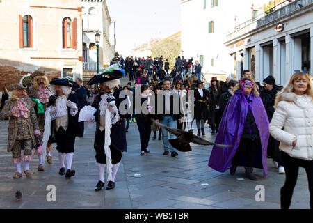 A crowded street of Venice during Carnival, some people are in masks. Stock Photo