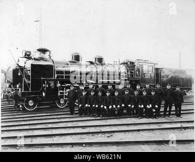 [ 1930s Japan - Japanese Steam Locomotive with Crew ] —   Train crew in front of the C51-239 steam locomotive, also known as the 'Royal Engine.' It pulled the Imperial Train 104 times.  C51-239 was manufactured at the Kisha Seizo Co. during 1927. The engine pulled express trains on the Tokaido main line. After WW2, it did duty on the Uetsu, Shinetsu and Hokuriku lines in Niigata Prefecture.  20th century vintage gelatin silver print. Stock Photo