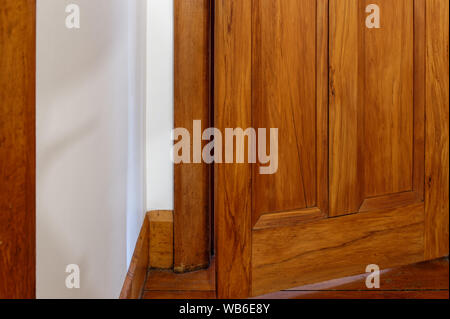 A door is open slightly, standing ajar inviting you to wonder what is on the other side Stock Photo