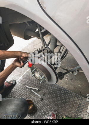 Change brake pads. Machanic change break pads on car. Stock Photo