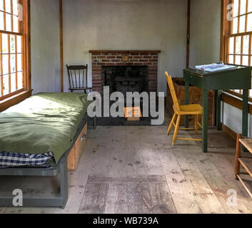 Concord, MA / USA - Oct 14, 2018: Inside the replica of Henry David Thoreau’s cabin at Walden Pond in autumn. The interior is furnished. Stock Photo