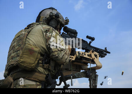 A Special Forces Soldier assigned to 3rd Special Group (Airborne) fires his M240 machine gun during a tactical vehicle live fire exercise on August 7, 2019, near Hurlburt Field, FL. The exercise was a part of a 3rd SFG (A) training rotation which encompasses various tactical techniques and procedures, including call for fire, full mission profiles and combat diver requalification. (U.S. Army photo by Spc. Peter Seidler) Stock Photo