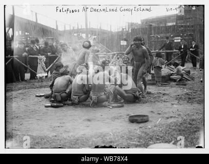 Filipinos in loin cloths sitting in circle together at Dreamland, Coney Island, N.Y. Abstract/medium: 1 negative : glass ; 5 x 7 in. or smaller. Stock Photo