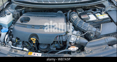 The engine and all the other parts of the car under the hood. Diesel engine from a famous car manufacturer. Stock Photo