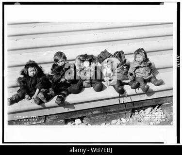 Five small Eskimo(?) children sitting bundled in fur garments] / F.H. Nowell, official photographer, Alaska-Yukon-Pacific Exposition Abstract/medium: 1 photographic print. Stock Photo