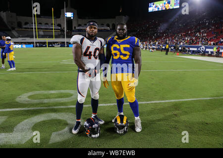 Los Angeles, CA., USA. 24th August, 2019. Narbonne High School graduates Denver Broncos linebacker Keishawn Bierria #40 and Los Angeles Rams defensive tackle Boogie Roberts #65 after the NFL game between Denver Broncos vs Los Angeles Rams at the Los Angeles Memorial Coliseum in Los Angeles, Ca on August 24, 2019. Jevone Moore Credit: Cal Sport Media/Alamy Live News Stock Photo
