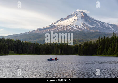 Trillium Lake, Mt. Hood National Forest, Oregon, United States of America - June 30, 2019: Family Canoeing in a beautiful lake with Hood Mountain in t Stock Photo