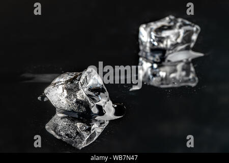 melting ice cubes on black background. close up Stock Photo