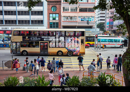 People waiting for green light at pedestrian crossing on Hennessy Road. Causeway Bay, Hong Kong, China. Stock Photo