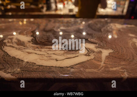 Bar counter detail made of gold-colored marble Stock Photo