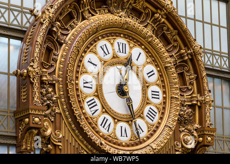 Paris, France - July 5, 2018: Golden clock of the museum D'Orsay. The Musee d'Orsay is a museum in Paris, on the left bank of the Seine. Golden colore Stock Photo