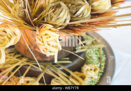 Arrangement of various types of pasta on display against a white background Stock Photo