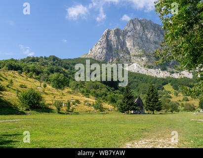 CAMPOCATINO, GARDFAGNANA, ITALY - AUGUST 9,2019: View of Campocatino landscape with Mount Roccandagia, Apuan Alps, behind and small chapel in front. Stock Photo