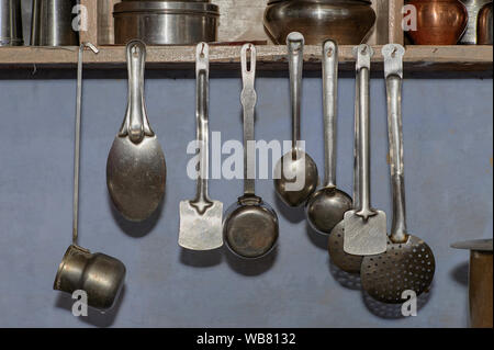 15 Feb 2010 stainless steel kitchen tools Mixed stainless steel kitchen tools hanging on log cabin wall Stock Photo