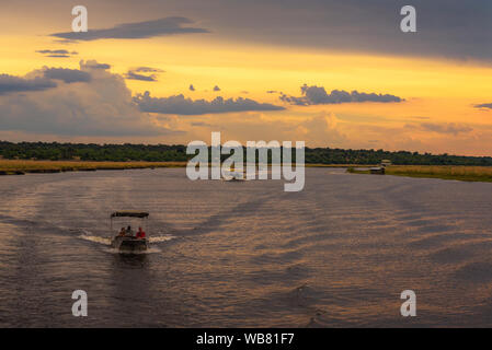 People on a sunset safari cruise on Chobe River in Chobe National Park, Botswana Stock Photo