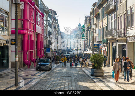 Porto, Portugal - November 17, 2017: Shoppers stroll on Rua Santa Catarina pedestrian street. View of the commercial street called Santa Catarina (Sai Stock Photo