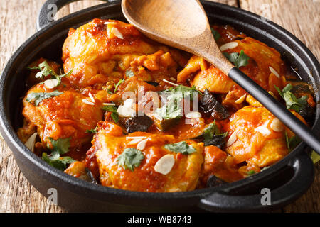 Moroccan Chicken with Eggplant, Tomatoes, and Almonds closeup on a plate on the table. Horizontal Stock Photo
