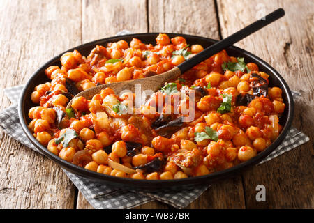 mnazaleh chickpeas with eggplant in tomato sauce close-up on a plate on the table. horizontal Stock Photo