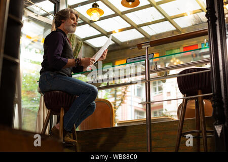 Man thinking of trying something new in a coffee shop. Stock Photo