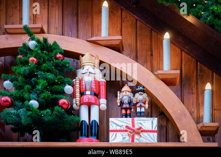 Nutcrackers and Glass Christmas tree decorations at Christmas market in Germany in Europe in winter. German street Xmas and holiday fair in European c Stock Photo